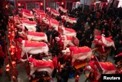 Slaughtered pigs are on display at a heaviest pig contest on the eighth day of the Chinese Lunar New Year of the pig, in Taizhou, Zhejiang province, China, Feb. 12, 2019.