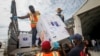 FILE - Boxes of a COVID-19 vaccine provided through the global COVAX initiative are unloaded at the airport in Mogadishu, Somalia, March 15, 2021.