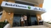 FILE - Customers wait outside a branch of the Bank of Khartoum, in Khartoum, Sudan, Sept. 11, 2017. 