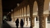 FILE - Students walk on the Stanford University campus in Santa Clara, California, March 14, 2019. 