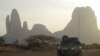 FILE - A French armored vehicle drives by Mount Hombori during France's Operation Barkhane in Mali's Gourma region, March 27, 2019.