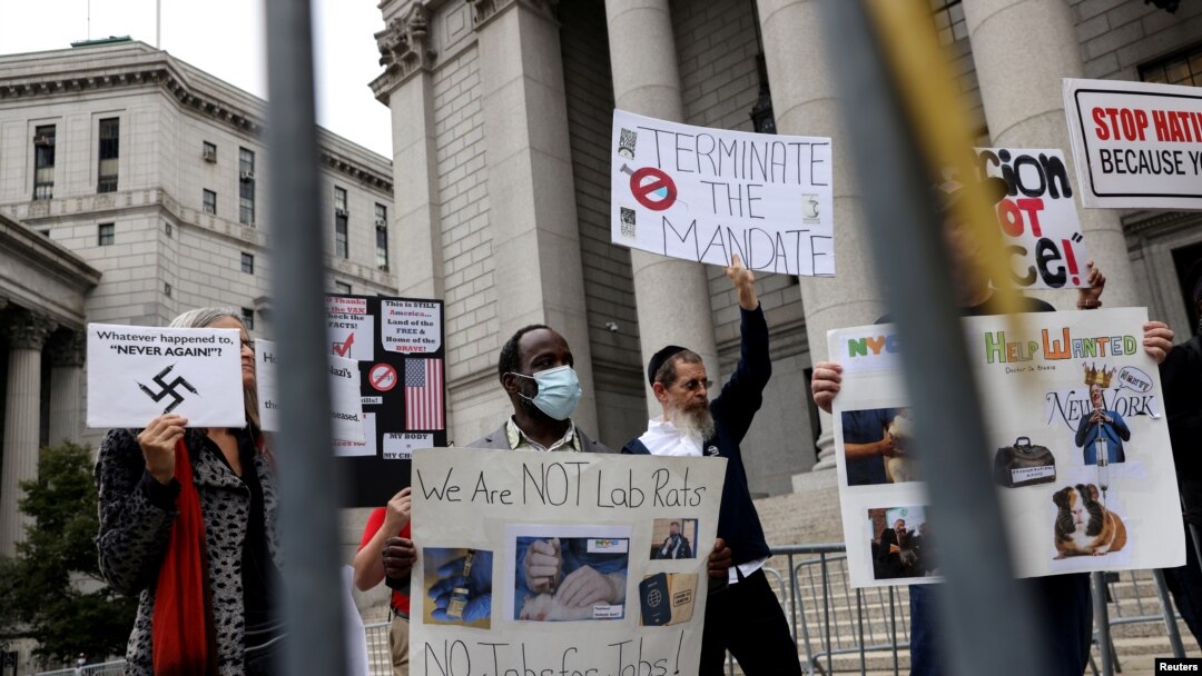 FILE - People and teachers protest against New York City mandated vaccines against the COVID-19 in front of the U.S. Courthouse in Manhattan, New York, Oct. 12, 2021.
