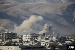 Smoke billows following Syrian government bombardments on the besieged rebel-held town of Hamouria in the eastern Ghouta region on the outskirts of the capital Damascus, March 3, 2018.