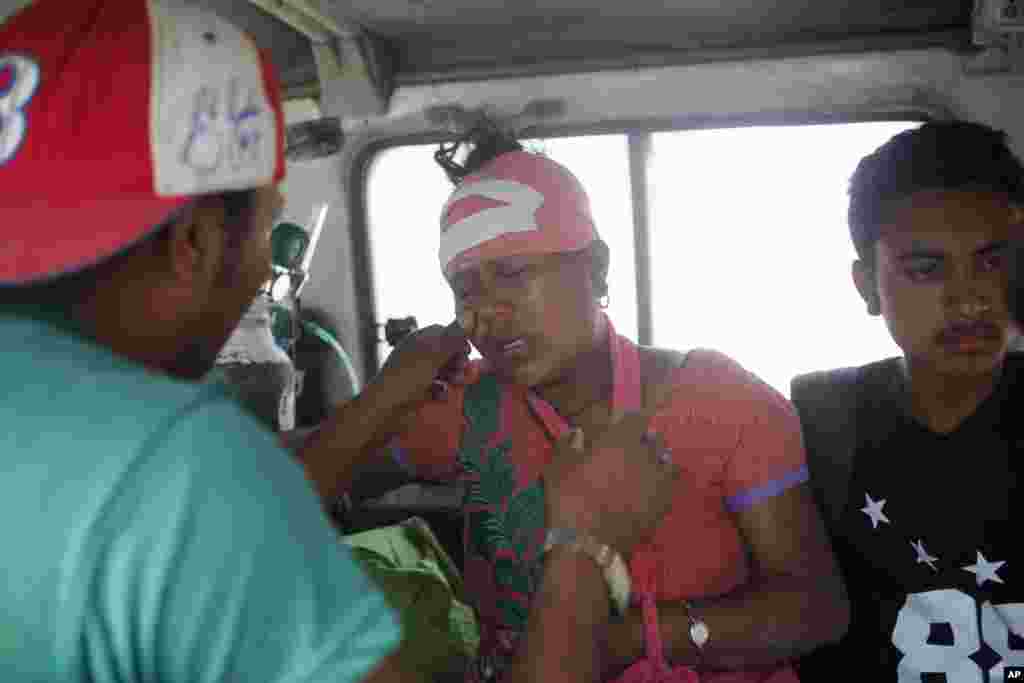 An injured Nepalese woman cries as she is taken to the hospital after another powerful earthquake hit Kathmandu in less than three weeks, May 12, 2015.