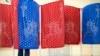 FILE - A voter marks a ballot inside a voting booth during a primary election, in Manchester, New Hampshire, Feb. 9, 2016.