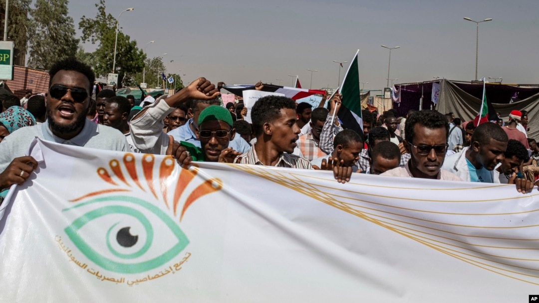 FILE - Protesters chant against military rule and demand the prosecution of former officials, at the Armed Forces Square, in Khartoum, Sudan, April 28, 2019.
