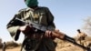 FILE - Malian soldiers patrol while training with U.S. soldiers in Gao, eastern Mali, Nov. 13, 2006.
