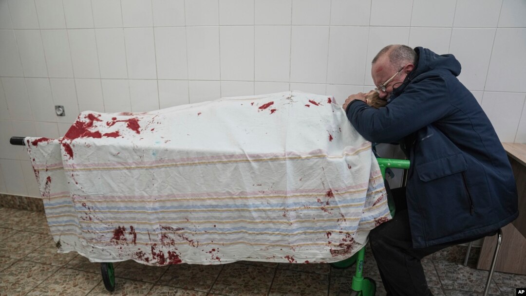FILE - In a scene in the documentary "20 Days in Mariupol," Serhii, father of teenager Iliya, cries on his son's lifeless body lying on a stretcher at a maternity hospital converted into a medical ward in Mariupol, Ukraine, on March 2, 2022.