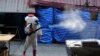 A worker sprays disinfectant as a precaution against the coronavirus at Klong Toey market in Bangkok, Thailand, Jan. 15, 2021.