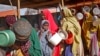 FILE - Women who fled drought queue to receive food at a camp for internally displaced persons, in the Daynile neighborhood on the outskirts of the capital Mogadishu, Somalia, May 18, 2019. 