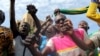 Anti-coup protesters sing the Burkinabe national anthem in Ouagadougou, Burkina Faso, Sept. 22, 2015. 