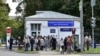 FILE - Journalists gather at a hospital where Russian opposition leader Alexei Navalny had been hospitalized, in Moscow, July 29, 2019. 