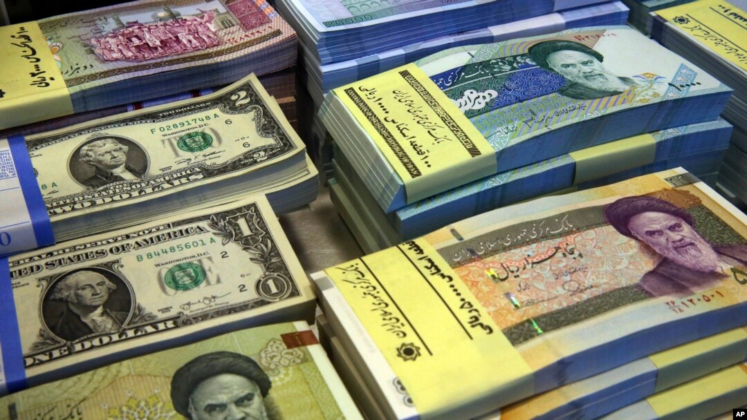 Iranian and U.S. banknotes are on display at a currency exchange shop in downtown Tehran, Iran, April 4, 2015.