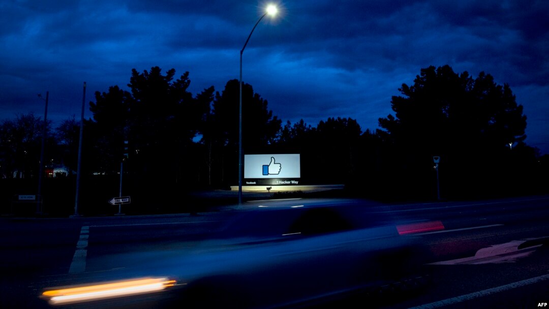 A car passes by Facebook's corporate headquarters location in Menlo Park, California, on March 21, 2018. 