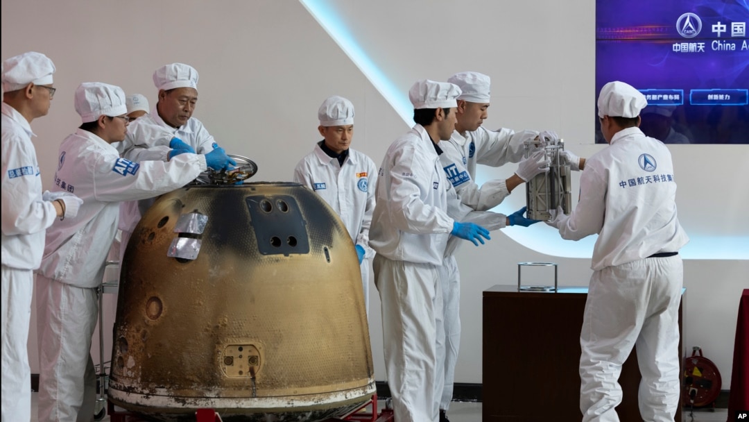 FILE - In this photo released by Xinhua News Agency, researchers prepare to weigh Chang'e 6 lunar samples at the China Academy of Space Technology under the China Aerospace Science and Technology Corporation, in Beijing on June 26, 2024. 