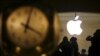 FILE - The Apple logo is pictured behind the clock at Grand Central Terminal in the Manhattan borough of New York, Feb. 21, 2016.