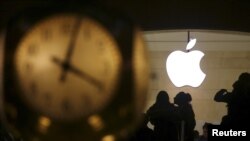 FILE - The Apple logo is pictured behind the clock at Grand Central Terminal in the Manhattan borough of New York, Feb. 21, 2016.
