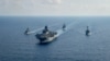 FILE - A Royal Australian Navy guided-missile frigate (L) sails with three US Navy ships in the South China Sea, April 18, 2020. (US Navy photo)