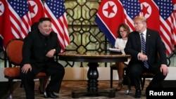 FILE - U.S. President Donald Trump looks toward North Korean leader Kim Jong Un during the one-on-one bilateral meeting at the second North Korea-U.S. summit in Hanoi, Vietnam, Feb. 28, 2019. 