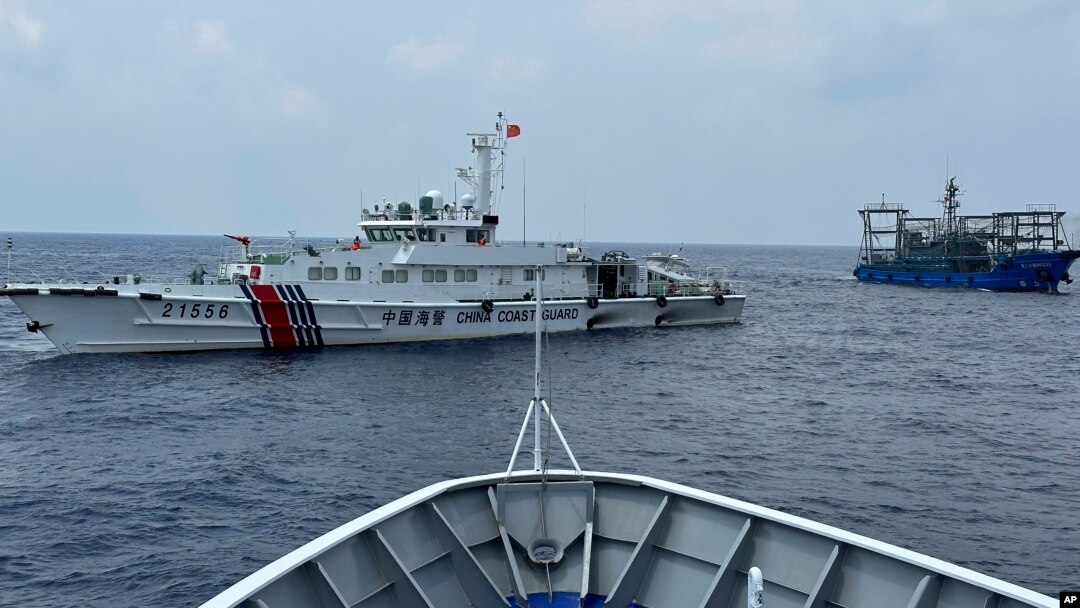 FILE - Two Chinese ships block a Philippine coast guard ship, foreground, headed for Second Thomas Shoal in the South China Sea, Oct. 4, 2023. The 2024 NATO summit is expected to touch on security and sovereignty issues in the area.
