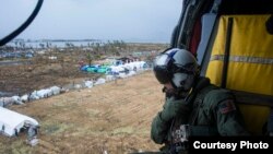 A U.S Navy aircrewman prepares to drop supplies from a MH-60S Seahawk, assigned to the USS George Washington at Tacloban Air Base in support of Operation Damayan, Nov. 14, 2013. (U.S. Navy photo/Ricardo R. Guzman)