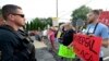 Watched by police, demonstrators against the Senate Republican health care bill await the arrival of Pennsylvania's U.S. Sen. Pat Toomey outside the studios of WHTM-TV, July 5, 2017 in Harrisburg, Pa.