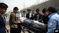 Foreign security personnel and Afghan police arrive at the site of an attack in Kabul, Afghanistan, March 6, 2020. Gunmen attacked a remembrance ceremony for a minority Shi'ite leader, killing more than two dozen people.