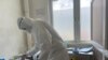 FILE - A member of medical staff wearing protective equipment, prepares to take care of patients amid the spread of the coronavirus disease (COVID-19), at an hospital in Douala, Cameroon, Apr. 27, 2020.