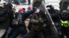 FILE - Riot police push back a crowd of Donald Trump supporters after they stormed the U.S. Capitol in Washington on Jan. 6, 2021.