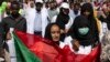 A protester carries a Sudanese flag as they chant against military rule and demand the prosecution of former officials, at the Armed Forces Square, in Khartoum, Sudan, April 28, 2019. 