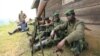 M23 rebel fighters rest at their defense position in Karambi, eastern Democratic Republic of Congo (DRC) in north Kivu province, near the border with Uganda, July 12, 2012. 