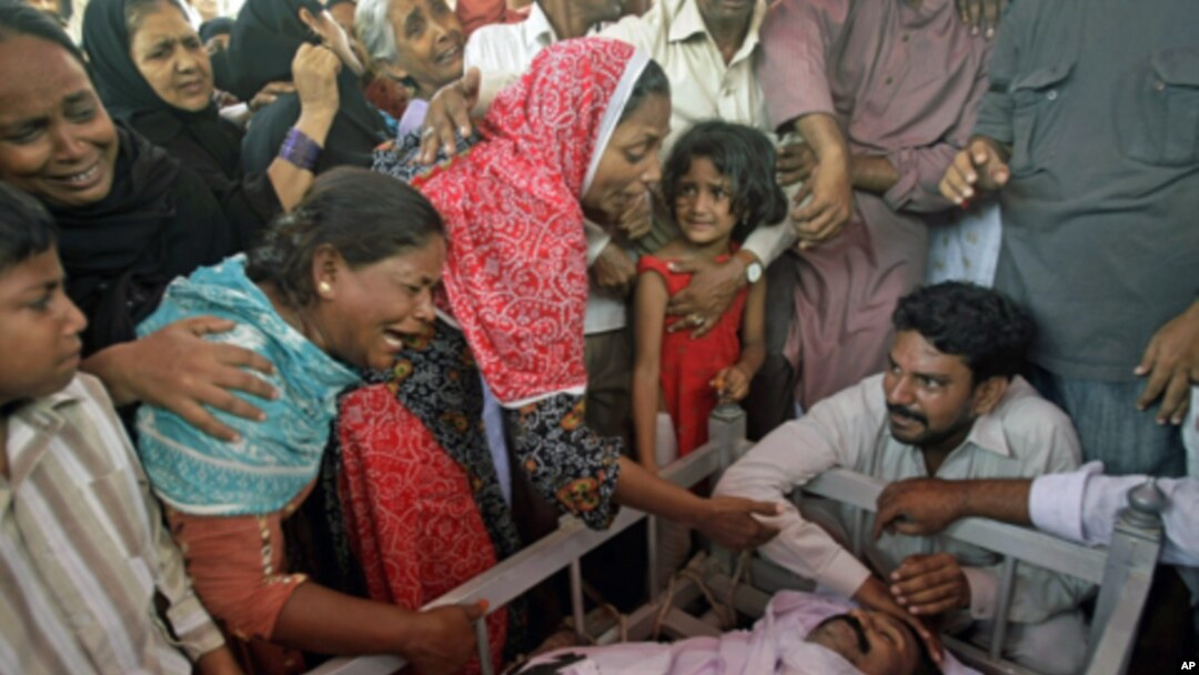 Pakistani family members mourn the death of a man shot dead amid unabated violence in Karachi, Pakistan, July, 8, 2011.