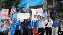 FILE - Uighur supporters march towards the Chinese Embassy after a Uighur protest rally at Dupont Circle in Washington.