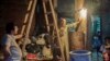 With rates continuing to rise, Egyptian families often reduce costs by limiting lighting to one bulb for an entire room. (H. Elrasam/VOA)