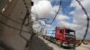 FILE - A truck carrying goods arrives at Kerem Shalom crossing in Rafah in the southern Gaza Strip, Aug. 15, 2018. 