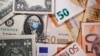 FILE PHOTO: George Washington is seen with printed medical masks on the one Dollar near Euro banknotes in this illustration