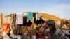 FILE - A general view of a makeshift shelter at the Faladie internally displaced people (IDP) camp in Bamako, Nov. 9, 2022. - People fleeing a decade-long conflict in Mali take refuge at the Faladie IDP camp. 