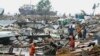 Residents search for their belongings amid the debis of their collapsed huts after the cyclone Sitrang hits in Chittagong, Bangladesh, Oct. 25, 2022.