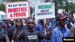 Supporters of the Peoples Democratic Party (PDP) protest at the national headquarters of the Independent National Electoral Commission (INEC) to disapprove the outcome of the February 25 election result in Abuja