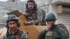 FILE - Turkish soldiers atop an armored personnel carrier secure the streets of the northwestern city of Afrin, Syria, March 24, 2018.