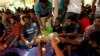 FILE - Ahmadi refugees from Pakistan eat at the Ahmadiyya Muslim Community Center in Pasyala, Sri Lanka, April 26, 2019. 