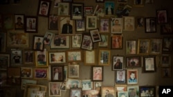 FILE - Pictures of Yazidis slain in 2014 by Islamic State militants are found in a small room at the Lalish shrine in northern Iraq, Sept. 12, 2019.