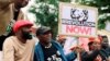 Nigerian activist and former presidential candidate Omoyele Sowore sits with activists during a protest over fuel and power price rises, near the U.S. embassy in Abuja, Nigeria, Oct. 1, 2020.