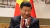 Chinese President Xi Jinping claps while addressing the media as he introduces new members of the Politburo Standing Committee at Beijing's Great Hall of the People Wednesday, Oct. 25, 2017.