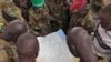 FILE - Soldiers from the Sudan People's Liberation Army (SPLA) are seen examining a map in Pana Kuach, Unity State, South Sudan.