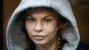 Anastasia Vashukevich, also known on social media as Nastya Rybka, sits in a cage in the court room in Moscow, Russia, Jan. 19, 2019.