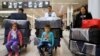 FILE - The al-Qassab family, Iraqi Christian refugees from Mosul, waits at the Beirut International Airport ahead of their travel to the United States, in Lebanon, Feb. 8, 2017.