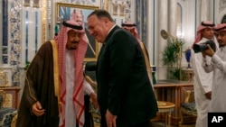 Secretary of State Mike Pompeo leans in to greet Saudi Arabia's King Salman during their meeting at Al-Salam Palace in Jeddah, June 24, 2019. 