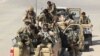 FILE - Afghan Special Forces arrive at the airport as they launch a counteroffensive to retake the city from Taliban insurgents, in Kunduz, Sept. 29, 2015. 
