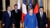 French President Emmanuel Macron, second left, Russian President Vladimir Putin, left, German Chancellor Angela Merkel and Ukrainian President Volodymyr Zelenskiy gather for talks at the Elysee Palace, in Paris, France, Dec. 9, 2019.